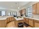 Bright kitchen features wood cabinets, stainless steel appliances, a kitchen island, and hardwood floors at 17423 Cornerstone Ln, Parker, CO 80134