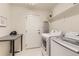Bright laundry room equipped with a washer, dryer, shelving, and a folding table at 17423 Cornerstone Ln, Parker, CO 80134