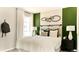 Comfortable bedroom showcasing a cozy bed with decorative pillows and a stylish green accent wall at 6601 E 148Th Dr, Thornton, CO 80602