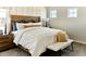 Inviting bedroom showcasing a wooden headboard, soft neutral tones, and a cozy white comforter at 6601 E 148Th Dr, Thornton, CO 80602