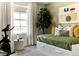 Inviting bedroom with daybed, large window, houseplant, and exercise bike at 6601 E 148Th Dr, Thornton, CO 80602