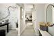 Bright hallway featuring modern decor, light hardwood floors, and a Colorado Trail themed accent wall at 6601 E 148Th Dr, Thornton, CO 80602