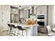 Modern kitchen featuring a large island, stainless steel appliances, and stylish pendant lighting at 6601 E 148Th Dr, Thornton, CO 80602