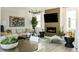 Elegant living room featuring a fireplace, modern chandelier, and stylish decor at 6601 E 148Th Dr, Thornton, CO 80602