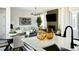 Stylish living room with modern furniture, fireplace, and ample natural light, connected to the kitchen at 6601 E 148Th Dr, Thornton, CO 80602