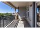 Balcony with metal railing and two chairs, offering outdoor seating and views of the surrounding neighborhood at 22932 E Ontario Dr # 102, Aurora, CO 80016