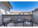 Small balcony with two chairs and a small table overlooking a well-maintained residential area at 22932 E Ontario Dr # 102, Aurora, CO 80016
