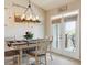 Cozy dining area with stylish lighting fixture, a table for four, and access to an outdoor space at 22932 E Ontario Dr # 102, Aurora, CO 80016