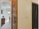 Hallway featuring a rustic wood sliding door and access to a sunlit room at 22932 E Ontario Dr # 102, Aurora, CO 80016