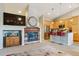 Open living area showcasing a modern fireplace, stainless steel appliances, and a breakfast bar at 22932 E Ontario Dr # 102, Aurora, CO 80016