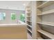 Bright loft area featuring large built-in shelving for storage or display at 22932 E Ontario Dr # 102, Aurora, CO 80016