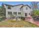 Expansive backyard with a patio, a play area, and a well-maintained lawn surrounded by lush landscaping at 8807 Tuscany Ln, Highlands Ranch, CO 80130