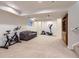 Spacious finished basement featuring an exercise bike, a stationary bike, and a sofa at 8807 Tuscany Ln, Highlands Ranch, CO 80130