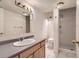Well-lit bathroom with a shower, vanity, and clean white tiled floor at 8807 Tuscany Ln, Highlands Ranch, CO 80130