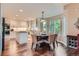 Bright dining area off kitchen featuring hardwood floors and natural light from large windows at 8807 Tuscany Ln, Highlands Ranch, CO 80130