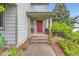 Inviting entryway with a red front door, brick accents, and decorative chairs at 8807 Tuscany Ln, Highlands Ranch, CO 80130