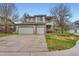 Charming two-story home features a well-maintained front yard and three-car garage at 8807 Tuscany Ln, Highlands Ranch, CO 80130