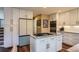 Modern kitchen with stainless steel appliances, custom white cabinets, and granite countertops at 8807 Tuscany Ln, Highlands Ranch, CO 80130