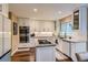 Spacious kitchen with a granite island, stainless appliances, and custom cabinets at 8807 Tuscany Ln, Highlands Ranch, CO 80130