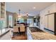 Open concept kitchen with a center island gas cooktop, dining area, and access to the living room at 8807 Tuscany Ln, Highlands Ranch, CO 80130