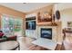 Living room showcasing a fireplace, a wooden mantle, and a sliding glass door to the backyard at 8807 Tuscany Ln, Highlands Ranch, CO 80130