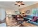Open concept floor plan featuring a living room with a large couch and hardwood floors at 8807 Tuscany Ln, Highlands Ranch, CO 80130