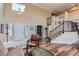 Open concept living room with staircase and an adjacent library or office at 8807 Tuscany Ln, Highlands Ranch, CO 80130