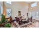 Comfortable living room with high ceilings, large windows, and hardwood floors at 8807 Tuscany Ln, Highlands Ranch, CO 80130