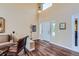 Bright living room with soaring ceilings, hardwood floors, and natural light at 8807 Tuscany Ln, Highlands Ranch, CO 80130
