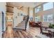Spacious living room with staircase, wood floors, and plenty of natural light at 8807 Tuscany Ln, Highlands Ranch, CO 80130