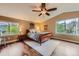 Spacious main bedroom with a ceiling fan and large windows bringing in lots of natural light at 8807 Tuscany Ln, Highlands Ranch, CO 80130
