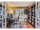 Cozy home office with built-in shelving and a comfortable work space at 8807 Tuscany Ln, Highlands Ranch, CO 80130