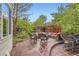 Charming outdoor patio with comfortable seating, perfect for entertaining guests in a serene garden setting at 8807 Tuscany Ln, Highlands Ranch, CO 80130