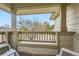 Inviting porch with wooden railings and seating, offering a peaceful view of the neighborhood at 8807 Tuscany Ln, Highlands Ranch, CO 80130