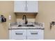 Close up of a convenient wet bar with modern fixtures and granite countertop at 8807 Tuscany Ln, Highlands Ranch, CO 80130