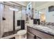 Modern bathroom with a glass-enclosed shower, granite countertops and updated fixtures at 19118 E 54Th Pl, Denver, CO 80249