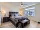 Primary bedroom features modern décor, a large window and a ceiling fan at 19118 E 54Th Pl, Denver, CO 80249