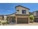 Two-story home featuring a two-car garage and a covered front porch under a clear blue sky at 19118 E 54Th Pl, Denver, CO 80249