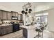 Modern kitchen with an island featuring granite countertops and barstool seating at 19118 E 54Th Pl, Denver, CO 80249