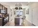 Well-lit kitchen features a central island with seating and stainless steel appliances at 19118 E 54Th Pl, Denver, CO 80249