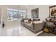 Modern living room with large windows, marble floors, contemporary furniture, and stylish décor at 19118 E 54Th Pl, Denver, CO 80249