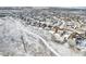 Aerial view of homes featuring green lawn and landscaping in winter at 6294 Long Branch Dr, Parker, CO 80134