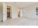 Bright bedroom with wood floors, windows, and ensuite bathroom and laundry access at 11454 Stonewash St, Littleton, CO 80125