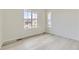 Bright bedroom with light wood floors, neutral paint, and large windows at 11454 Stonewash St, Littleton, CO 80125