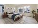 Bright and airy bedroom with large windows, neutral decor, and a comfortable king-size bed at 11454 Stonewash St, Littleton, CO 80125