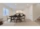 Dining area and bar with modern table, chairs, cabinetry, and natural light at 11454 Stonewash St, Littleton, CO 80125