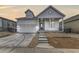 Charming exterior elevation with a concrete driveway, walkway, and covered entryway at 11454 Stonewash St, Littleton, CO 80125