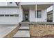 Inviting front entrance with concrete steps and a covered porch, leading to a stylish front door at 11454 Stonewash St, Littleton, CO 80125