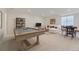Large game room with a pool table, lounge area, and window at 11454 Stonewash St, Littleton, CO 80125