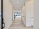 Long hallway with white walls, modern doors, and wood floors leading to the living space at 11454 Stonewash St, Littleton, CO 80125